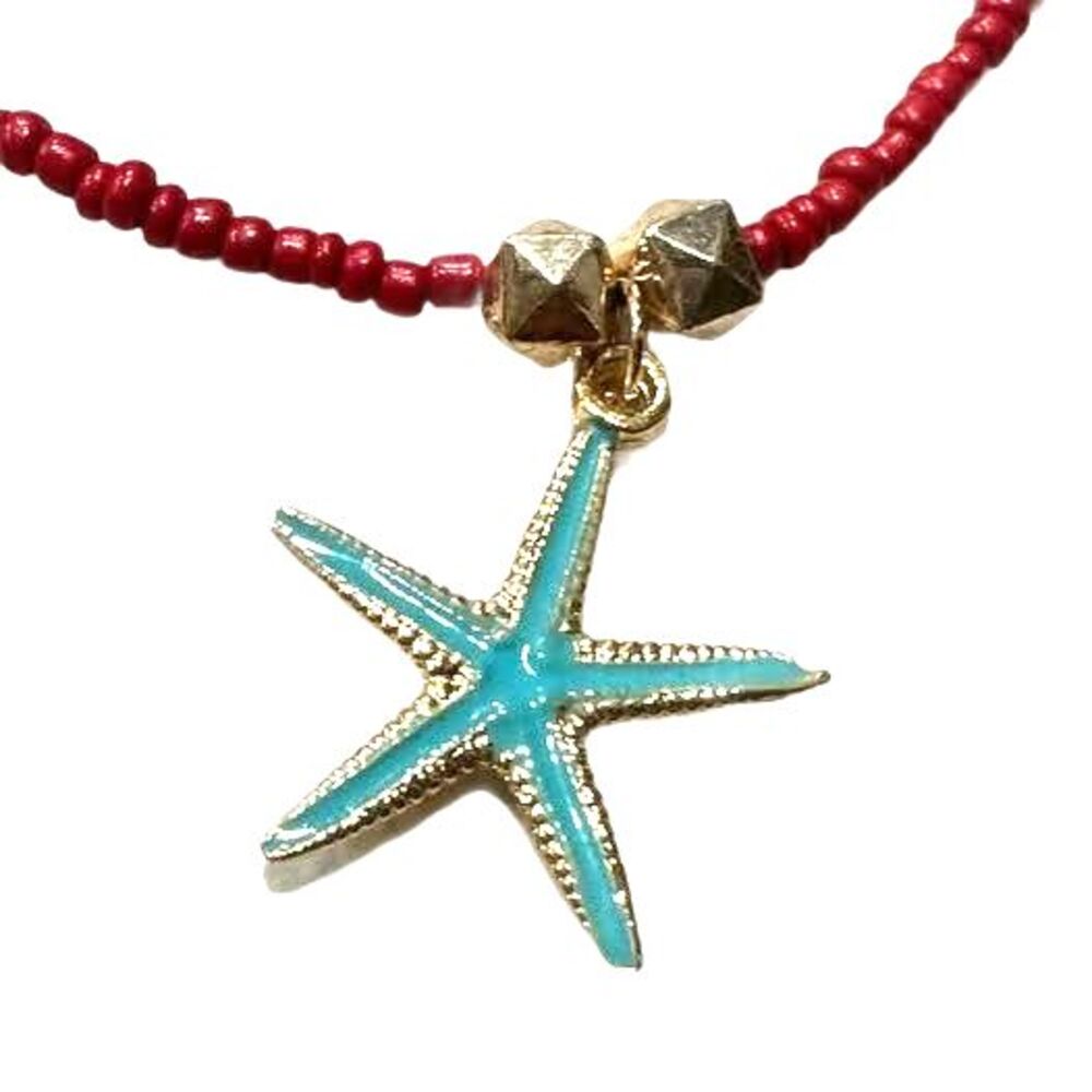 NWT Elegant red beaded necklace featuring a charming starfish pendant.